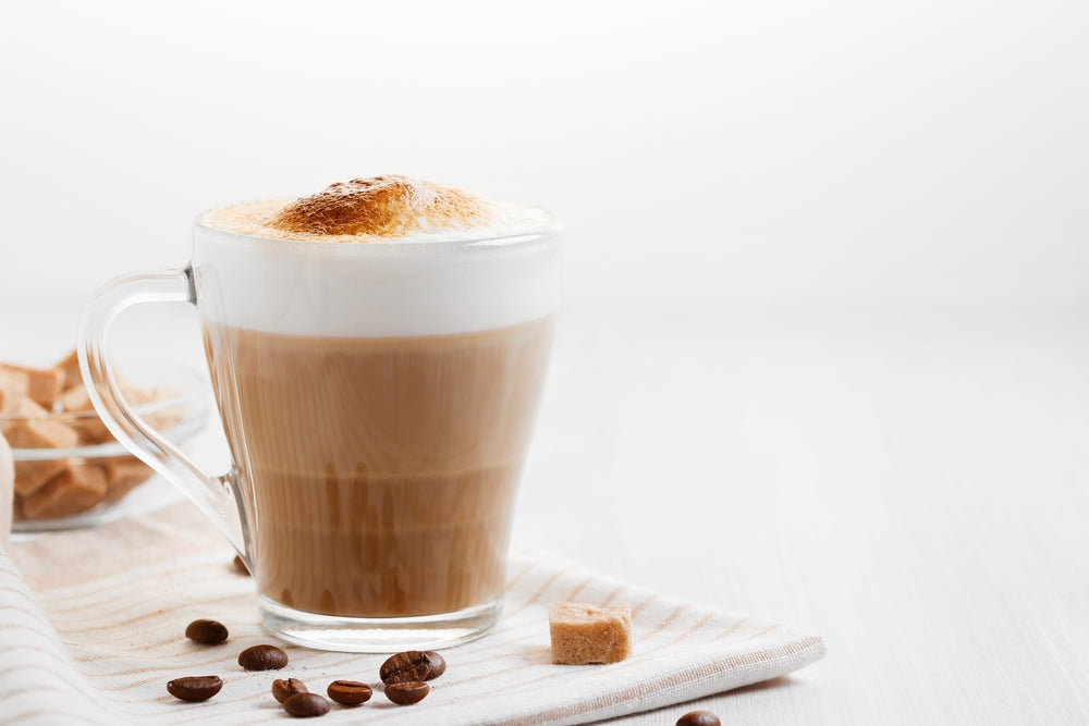 Latte coffee poured in layers with froth and a crispy chocolate top.