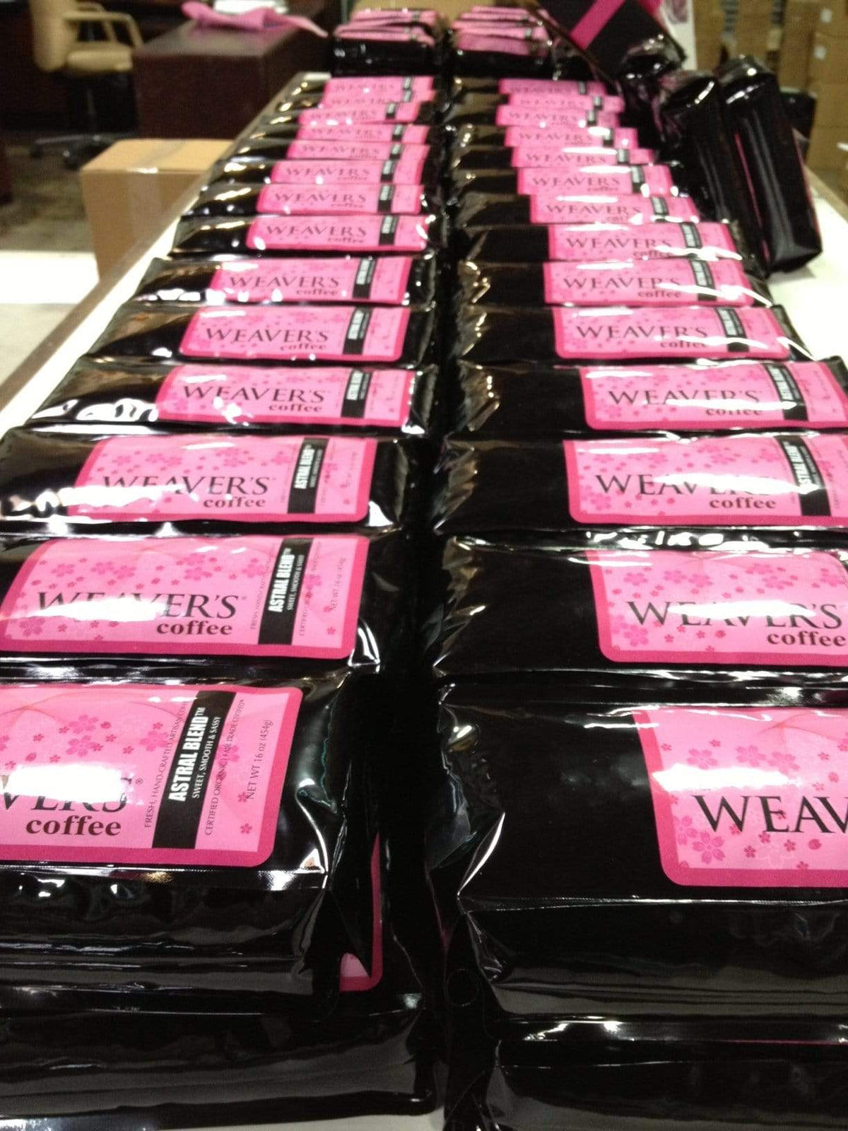 weaverscoffee.mom Dozens of Coffee bags of Astral Blend Coffee lined up in a row.